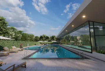 Luxury swimming pool with sun loungers and modern clubhouse in Ajman, UAE—part of homes for sale with premium amenities