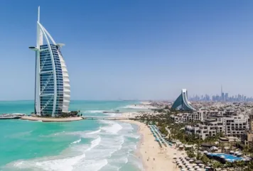 Luxury beachfront view in Dubai featuring Burj Al Arab, Jumeirah Beach, and skyline—ideal for homes for sale in prime locations.